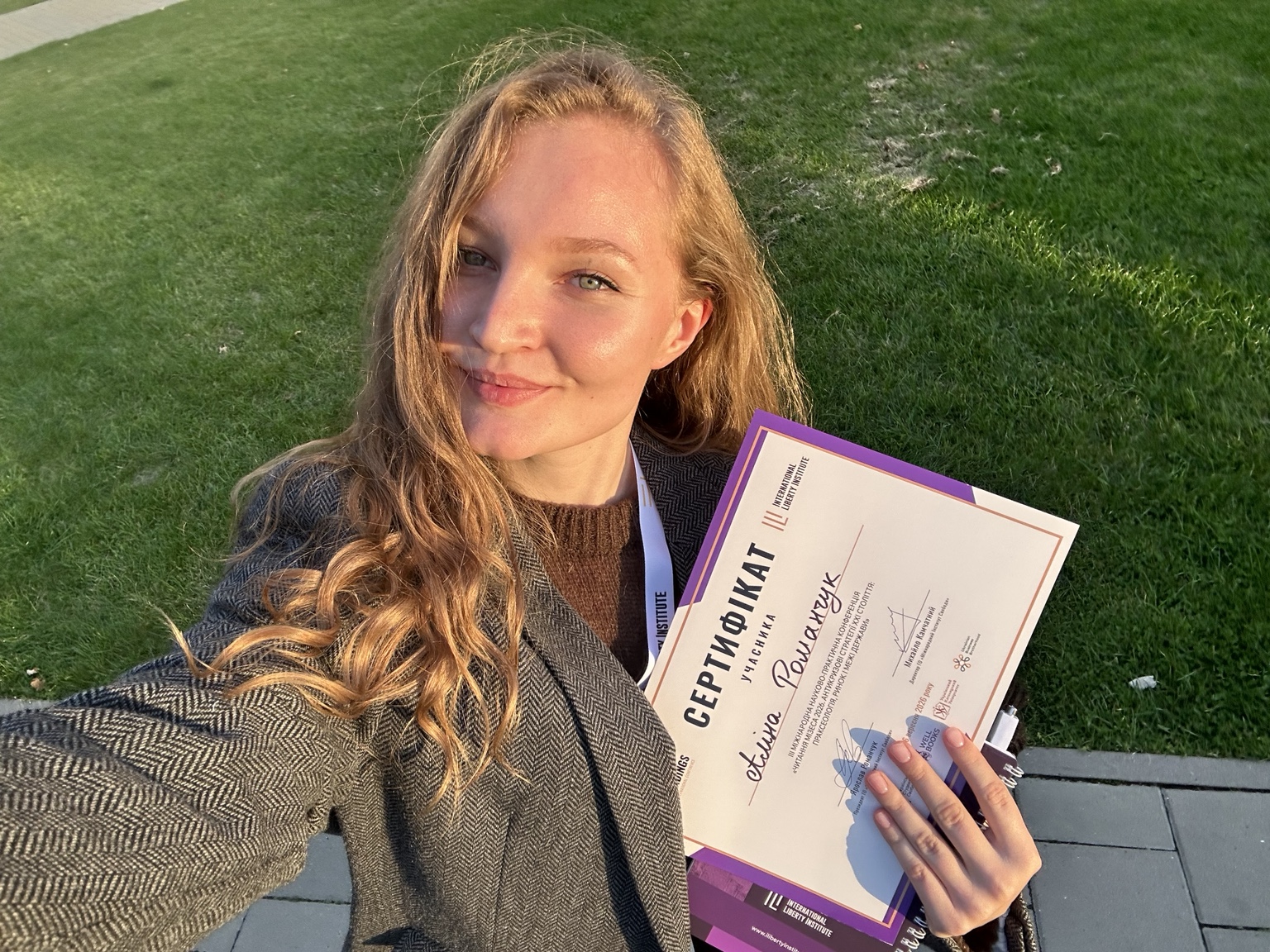 Alina holding her certificate
